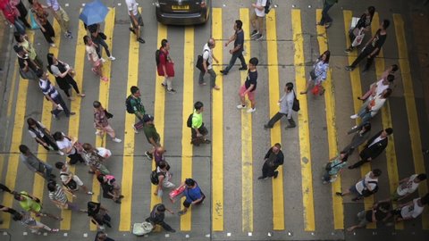 Hong Kong China 6 July 2019 : Slow motion aerial view crowd people transporting crossing street in Mong Kok famous shopping market in Hong Kong China. Asia business, lifestyle, transportation concept.