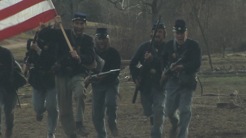 PETERSBURG, VIRGINIA - MARCH 2019 - Large-scale, epic Civil War reenactment -- battle in the trenches.  Union and Confederate soldiers firing and fighting, charging with cannon explosions and smoke.
