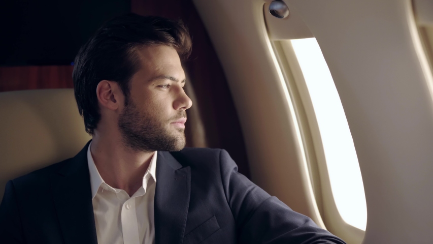 happy businessman traveling by plane and listening music in wireless earphones Royalty-Free Stock Footage #1049107405