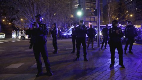 MADRID, SPAIN – MARCH 25 2020. A group of Madrid Municipal Police officers applaud medical workers from the Fundacion Jimenez Diaz hospital who are fighting coronavirus
