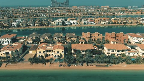Low altitude aerial view of many luxury villas on the Palm Jumeirah island in Dubai. UAE