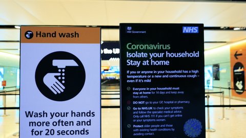 LONDON, circa 2020 - Close-up view of 2 CORONAVIRUS information panels in a popular UK airport, with practical advice and recommendations, following the rise in the number of cases of COVID-19