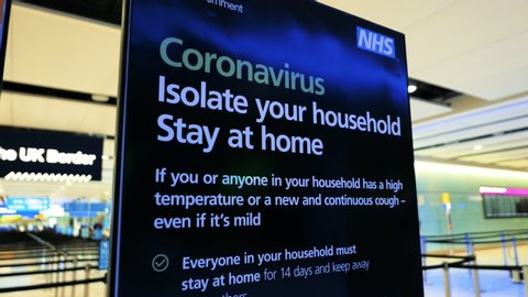 LONDON, circa 2020 - Close-up view of a CORONAVIRUS information panel in a popular UK airport, urging people to stay at home, following the number of cases of CORONAVIRUS / COVID-19 infections