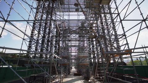 Construction of a bridge with scaffolding. Under construction of metal steel framework