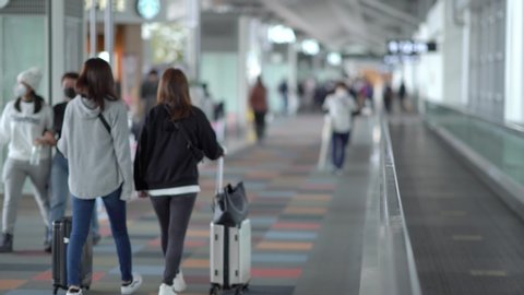 Nagoya, Japan - Feb. 3, 2020: Selective focus on walkalator with passengers are seen walking to gate at Chubu Centrair International Airport. The Covid-19 pandemic just started at this time.