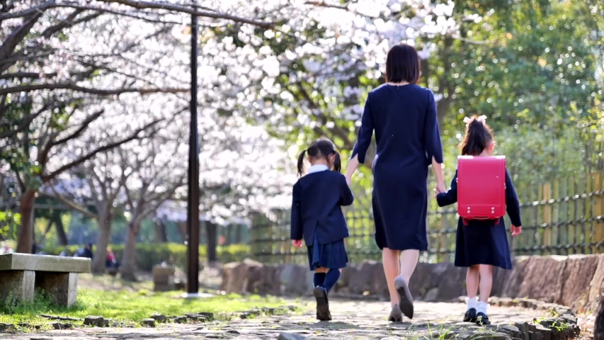 Japanese mother and child's family walking towards elementary school entrance ceremony Royalty-Free Stock Footage #1049139043