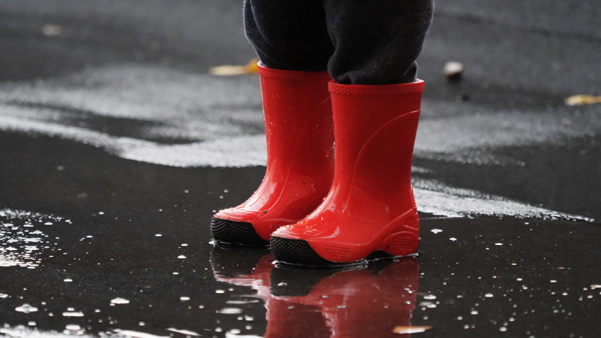 Rain pool. Red Rubber Boots Dirt. Rain Splash.