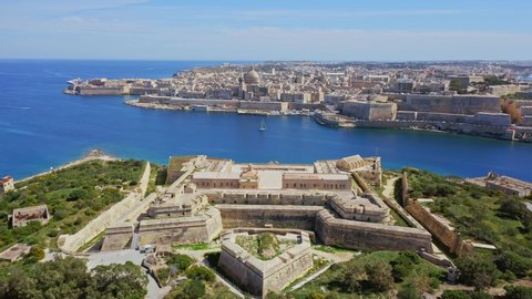 Aerial view of Fort Manoel and Valletta - capital of Malta. Drone flights forward. Mediterranean see, green nature
