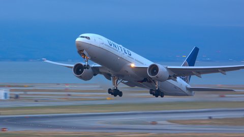 SAN FRANCISCO, CA - 2020: United Airlines Boeing 777-200 Jet Airliner Taking Off from Runway Departing San Francisco SFO International Airport Flying into a Blue Early Evening Sky in California