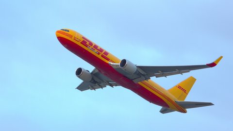 SAN FRANCISCO, CA - 2020: DHL Boeing 767 Cargo Jet Freighter Airplane Taking Off from Runway Departing San Francisco SFO International Airport Flying into a Blue Early Evening Sky in California