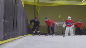 Panning of several female hockey players wearing uniform having training in indoor ice rink. One player falling down on ice - Powered by Shutterstock - Get 15% off with code: PIKWIZARD15