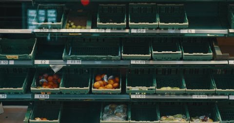 Bristol, England - March 24 2020: Bare grocery shelves in food market / supermarket during Coronavirus pandemic