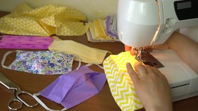 Eco-friendly Upcycled mask, Cotton Face Mask. A Woman volunteer Sew at Home a Fabric Face Mask Washable and Reusable - Powered by Shutterstock - Get 15% off with code: PIKWIZARD15