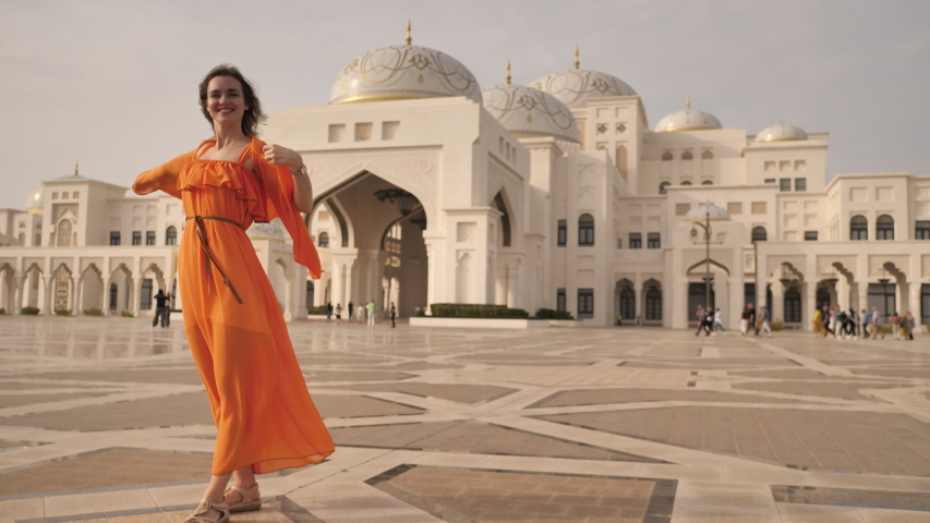 Girl posing against the backdrop of Qasr Al Watan, UAE Presidential Palace in Abu Dhabi.