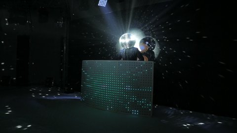 dj dancing with disco ball on his head at discolights