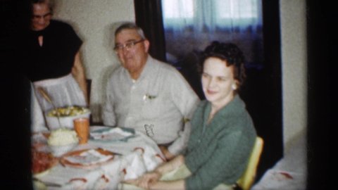 INDIANA-1959: Older Woman Wearing Black Dress With White apron with Two Men On Shoulders One Younger One Older