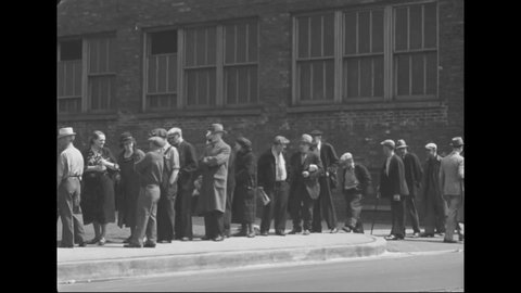 CIRCA 1930s - A long line of people is seen waiting outside the Chicago Relief Administration office during the Great Depression in America.