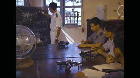CIRCA 1962 - South Vietnamese sailors are trained to use a sextant in the classroom and at sea.
