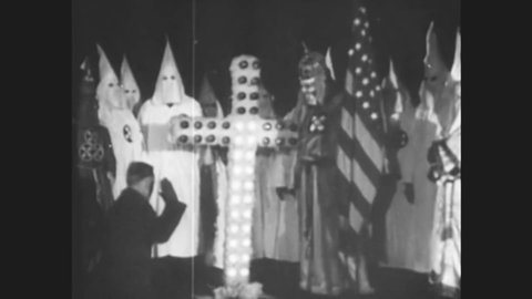 CIRCA 1920s - At a racist KKK rally in Stone Mountain, Georgia, a cross is burned at night.