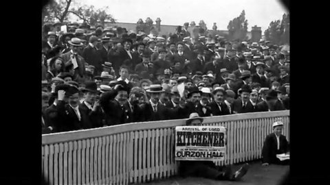 CIRCA 1902 - Men, women and children wave hats and handkerchiefs as excited sports spectators in Birmingham, England.