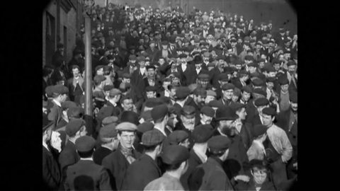 CIRCA 1900 - Thousands of employees enter Lord Armstrong's Elswick Works in Newcastle-upon-Tyne, England.