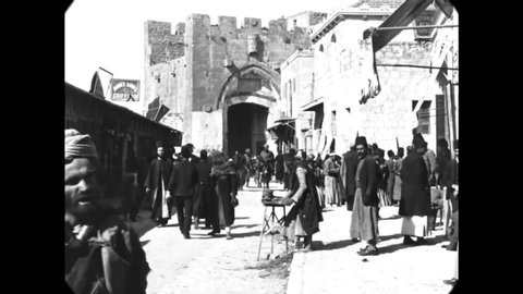 CIRCA 1897 - People walk past Jaffa Gate in Jerusalem.