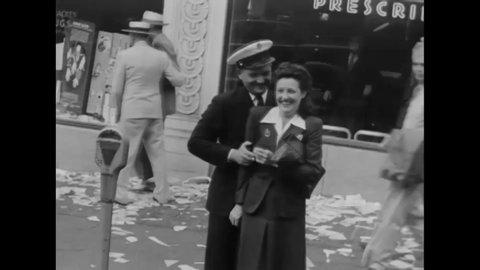 CIRCA 1945 - Men and women of the US Navy celebrate the end of World War two V-J Day with civilians in Seattle Washington.