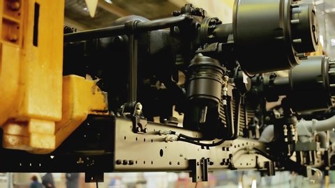 Close up of the process of car assembly at the production line. Stock footage. Rotating detail of the mechanism at the car assembly factory, construction concept.