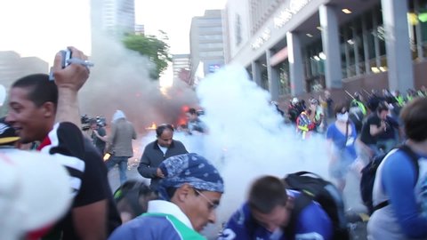Vancouver, Canada - June 15 2011 - Chaotic tense scene of riot with explosive tear gas and people running around