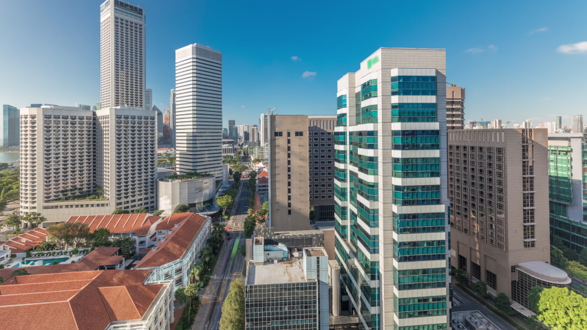 A beautiful morning panorama with Marina Bay area and skyscrapers city skyline aerial timelapse. The tower shape building at the North bridge road with traffic in Singapore.
