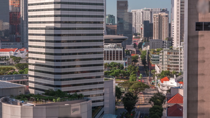 A beautiful morning panorama with Marina Bay area and skyscrapers city skyline aerial timelapse. The tower shape building at the North bridge road in Singapore.