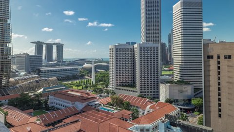 A beautiful morning panorama with Marina Bay area and skyscrapers city skyline aerial timelapse hyperlapse. The tower shape building at the North bridge road in Singapore.