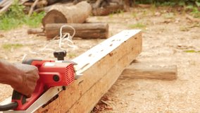 Slow motion video clip for carpenters to plan wood using electric planer with advanced expertise. Woodworking concepts.