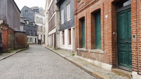 HONFLEUR, FRANCE - APRIL 08, 2018: view of empty beautiful street with old traditional houses at the center of Honfleur, Normandy, France
