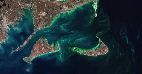 Very high-altitude overflight aerial of phytoplankton blooms off Cape Cod. Clip loops and is reversible. Elements of this image furnished by NASA