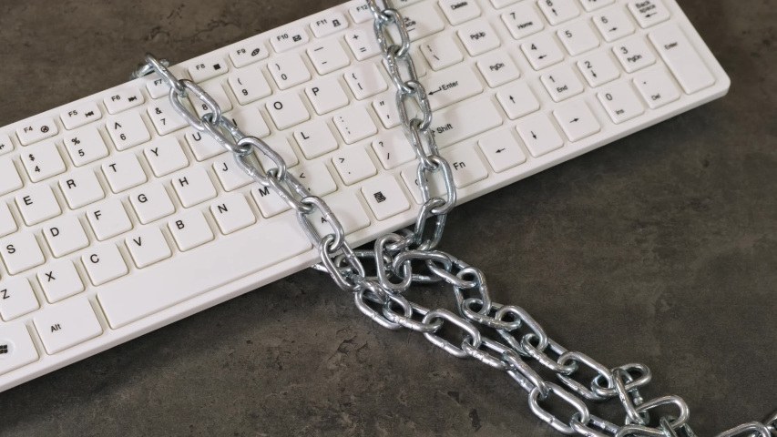 Hand close lock with chain on keaboard. Close up.