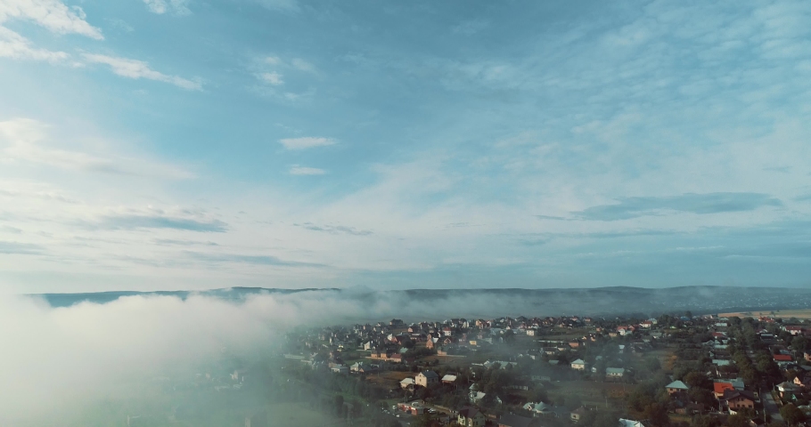 4K aerial view of morning light mist over the small town.