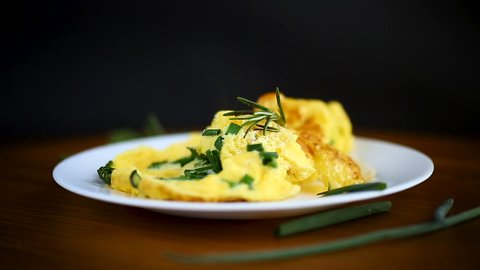 hot fried omelet with chopped green onions in a plate