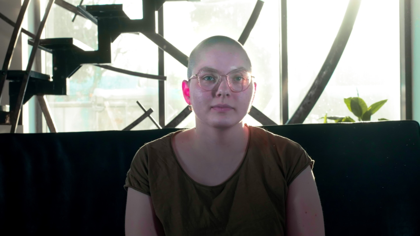 Lesbian bald girl rejoices in victory over cancer or hiv. Raises his hands up, celebrates the victory, healed. Strong and happy breast cancer survivior woman - breast cancer awareness concept.