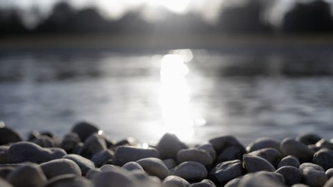 Isar river in backlight with stones in foreground munich bavaria germany 03.27.2020