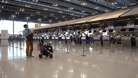 Bangkok Suvarnabhumi airport passengers check in for the flight at the departure terminal, people in medical masks from coronavirus. Thailand Bangkok March 2020