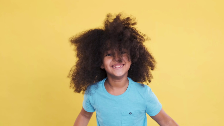 Energy Active Multiracial Child Dancing, Having Fun and Looking in Camera. She Jumping, Waving Her Curly Hair. Concept of Freedom, Independence, Good Feelings, Success, Confidence. Slow motion. Royalty-Free Stock Footage #1049354773