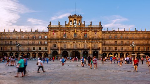 Salamanca, Spain. Crowded Plaza Mayor in Salamanca, Spain during a sunny evening. Time-lapse of motion blurred people in front of the famous landmark, zoom in