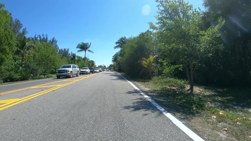 Driving down the road to Sanibel Island - Florida Fort Myers - first person view