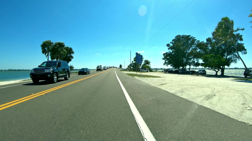 Driving down the road to Sanibel Island - Florida Fort Myers - first person view