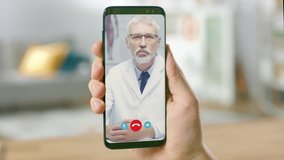 Point of View: Man Using Smartphone to Talk to His Doctor via Video Conference Medical App. Person Checks Symptoms, Talks with Physician, Using Online Video Chat Application. Close-up POV Camera