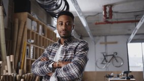 Portrait of young male business owner in workshop for building sustainable handmade bamboo bicycles - shot in slow motion - Powered by Shutterstock - Get 15% off with code: PIKWIZARD15