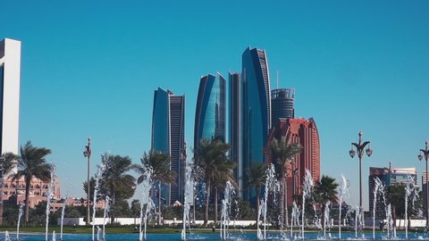 View of Abu Dhabi Skyscrapers and Fountains in United Arab Emirates (UAE) on Sunny Day with Clear Blue Sky