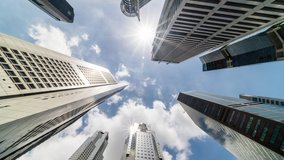 Time-lapse of skyscraper buildings in business district, Singapore city. Cloud on sunny day sky. Low angle view, zoom out. Asia financial economy, merger & acquisition, or modern architecture concept - Powered by Shutterstock - Get 15% off with code: PIKWIZARD15