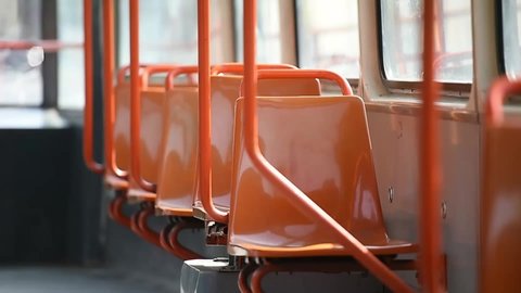 Empty orange chairs in an empty public tram during coronavirus pandemic in Bucharest, Romania